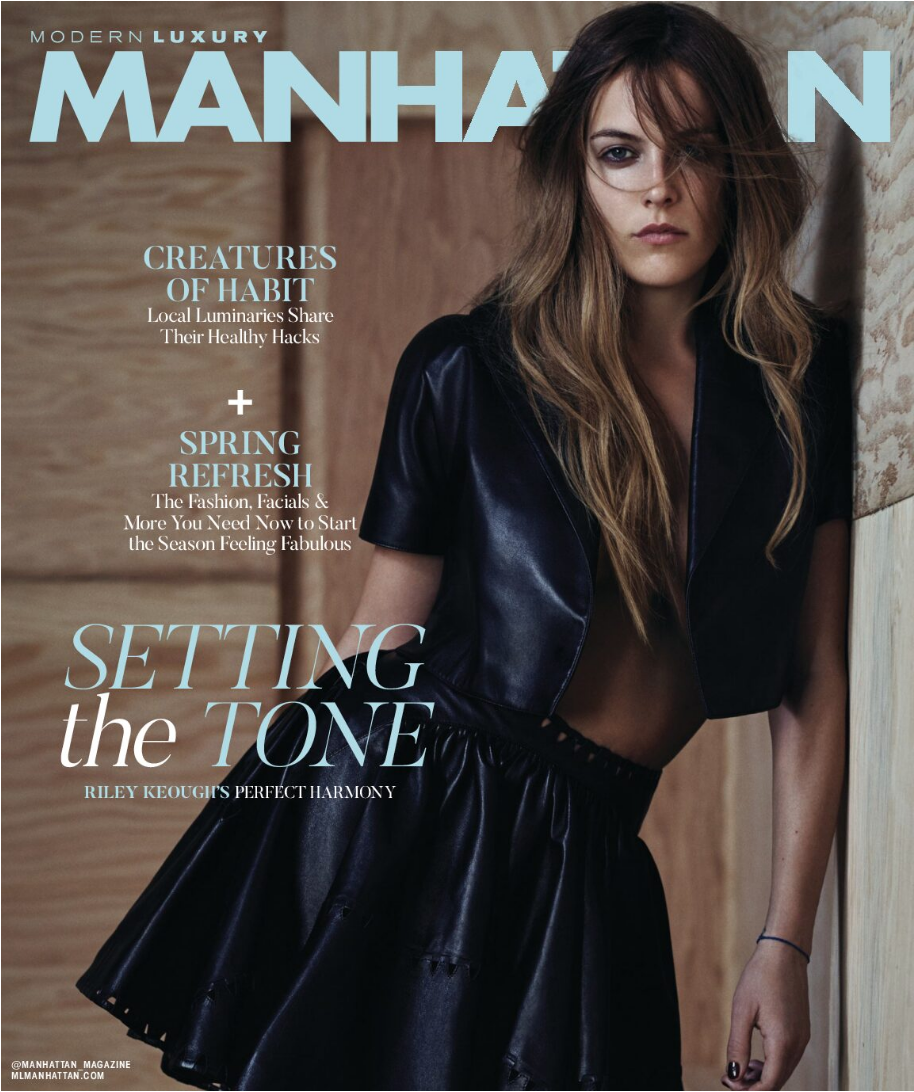 A woman in a black leather outfit poses with her left hand touching a wooden wall. She has long, wavy hair partially covering her face. The magazine cover includes text about fashion and lifestyle topics, with Setting the Tone as the main headline.